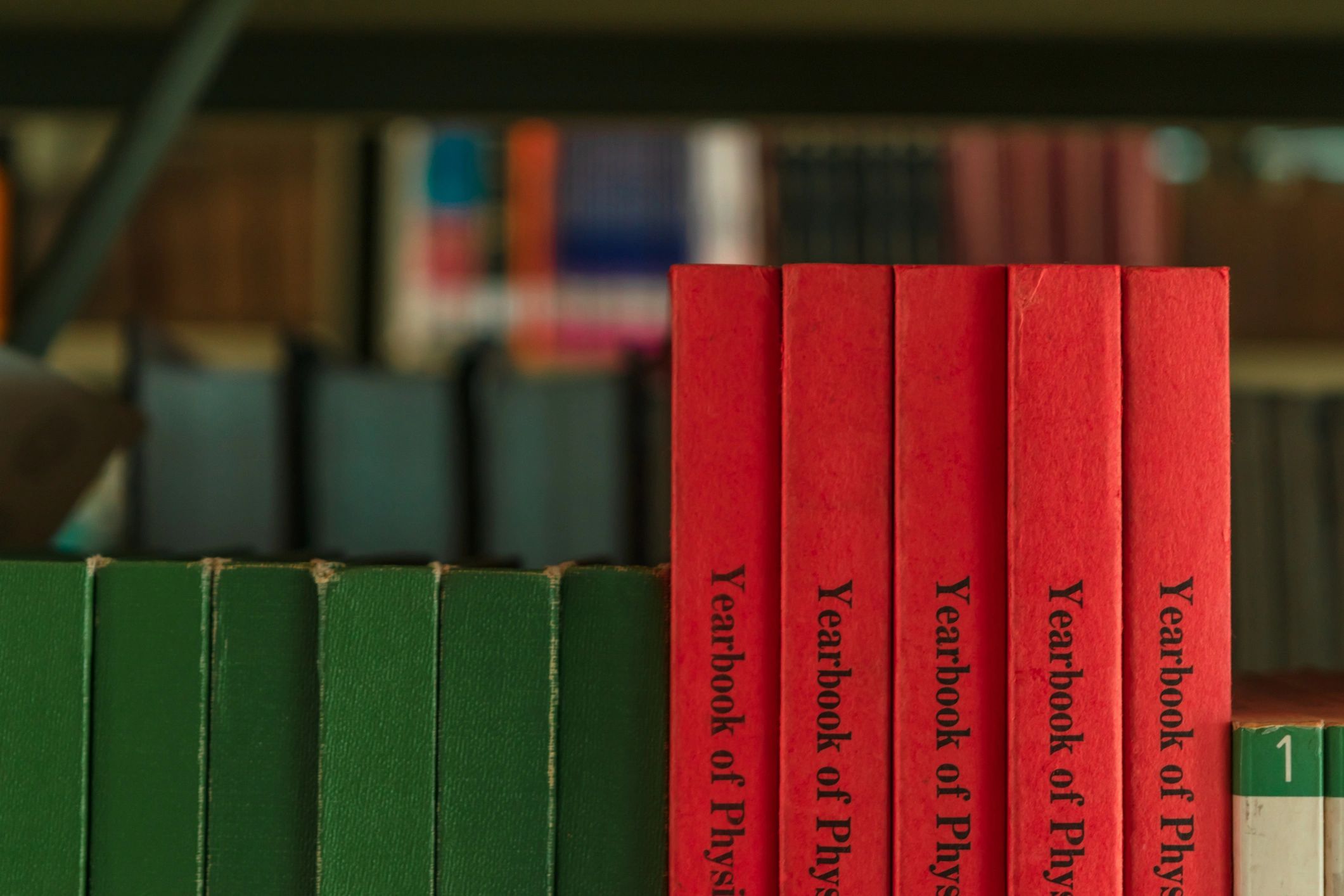Close-up of stacked books in warm tones