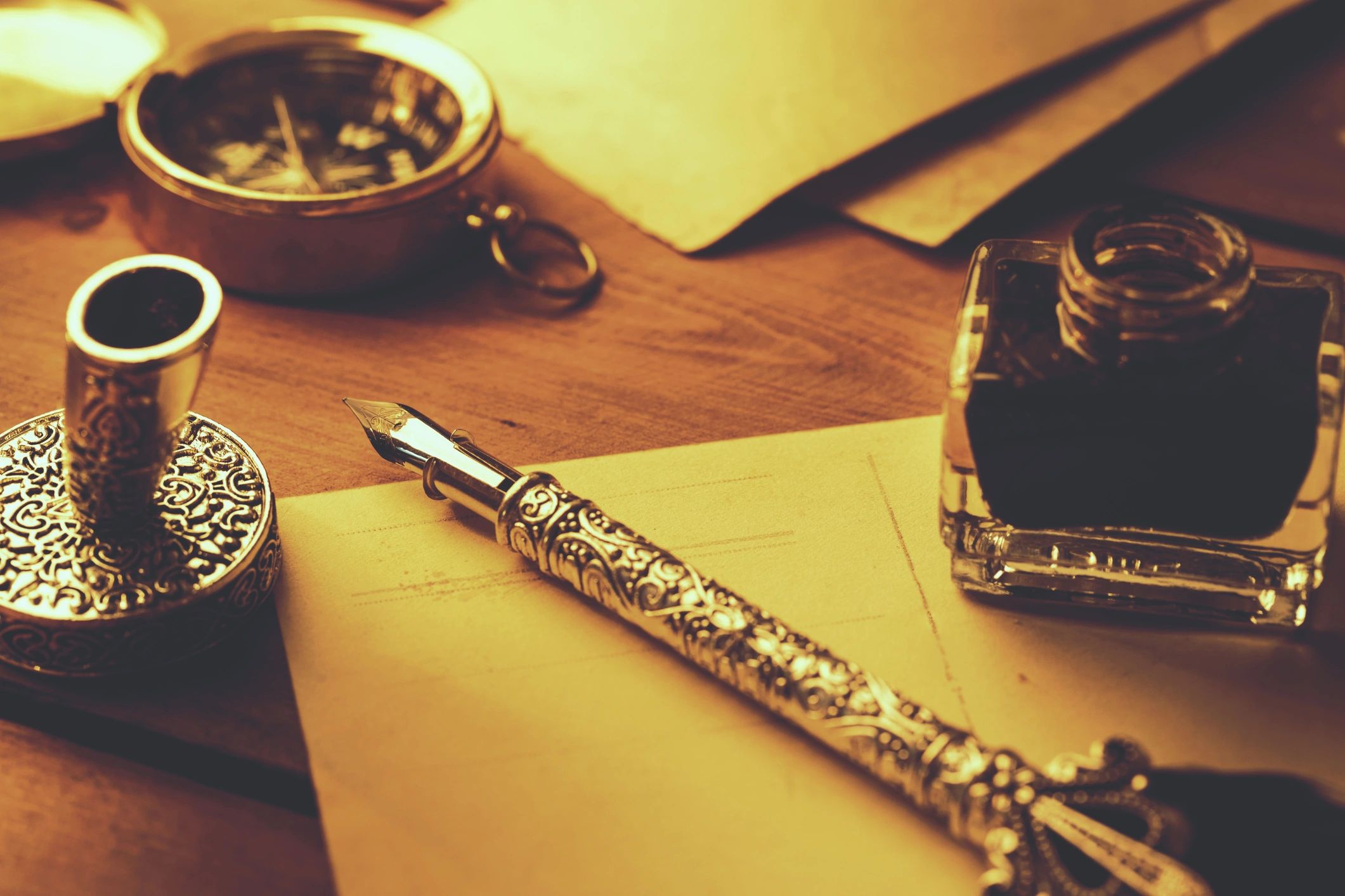 Vintage feather pen and parchment on a desk