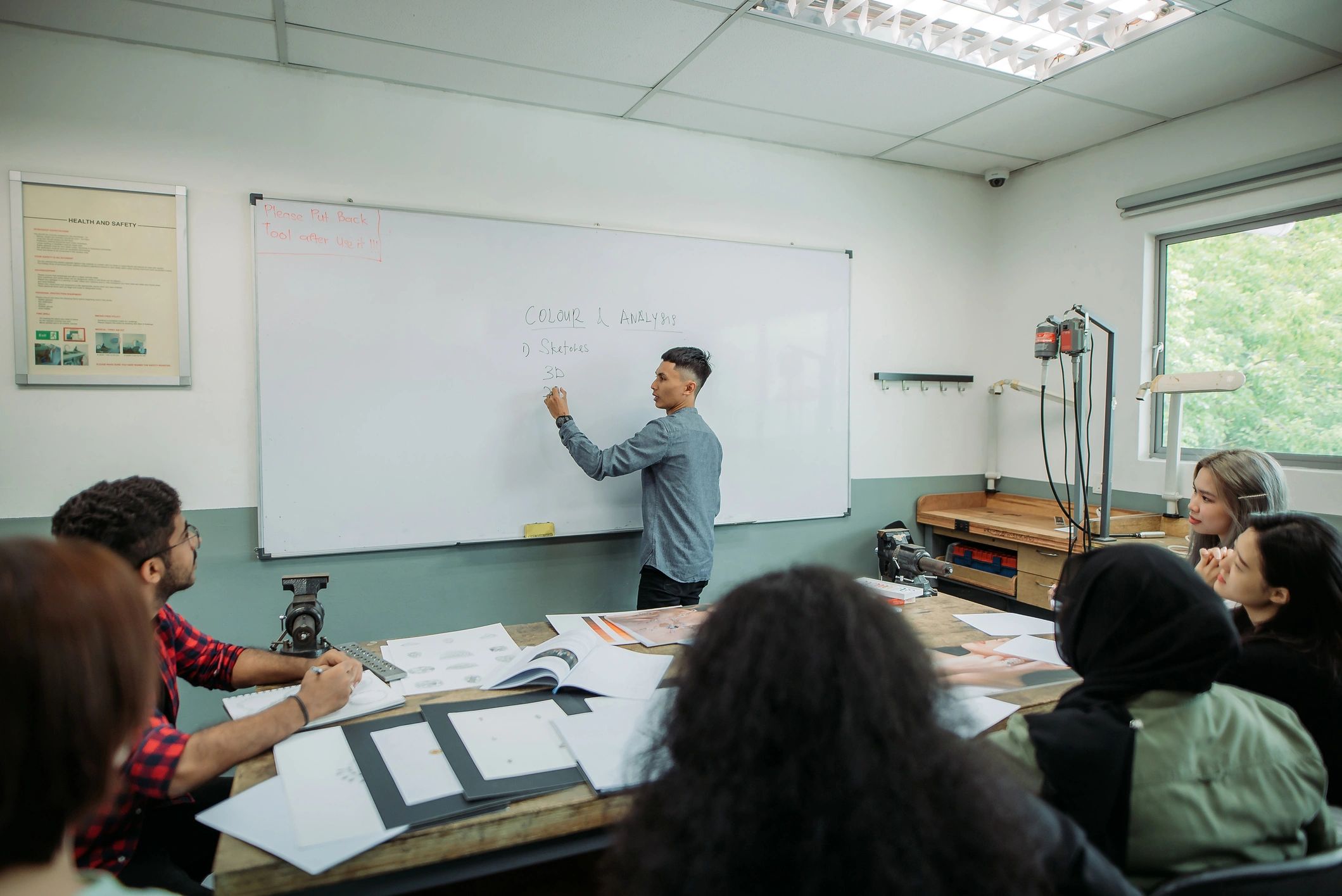 Writing workshop in progress with instructor and adult students