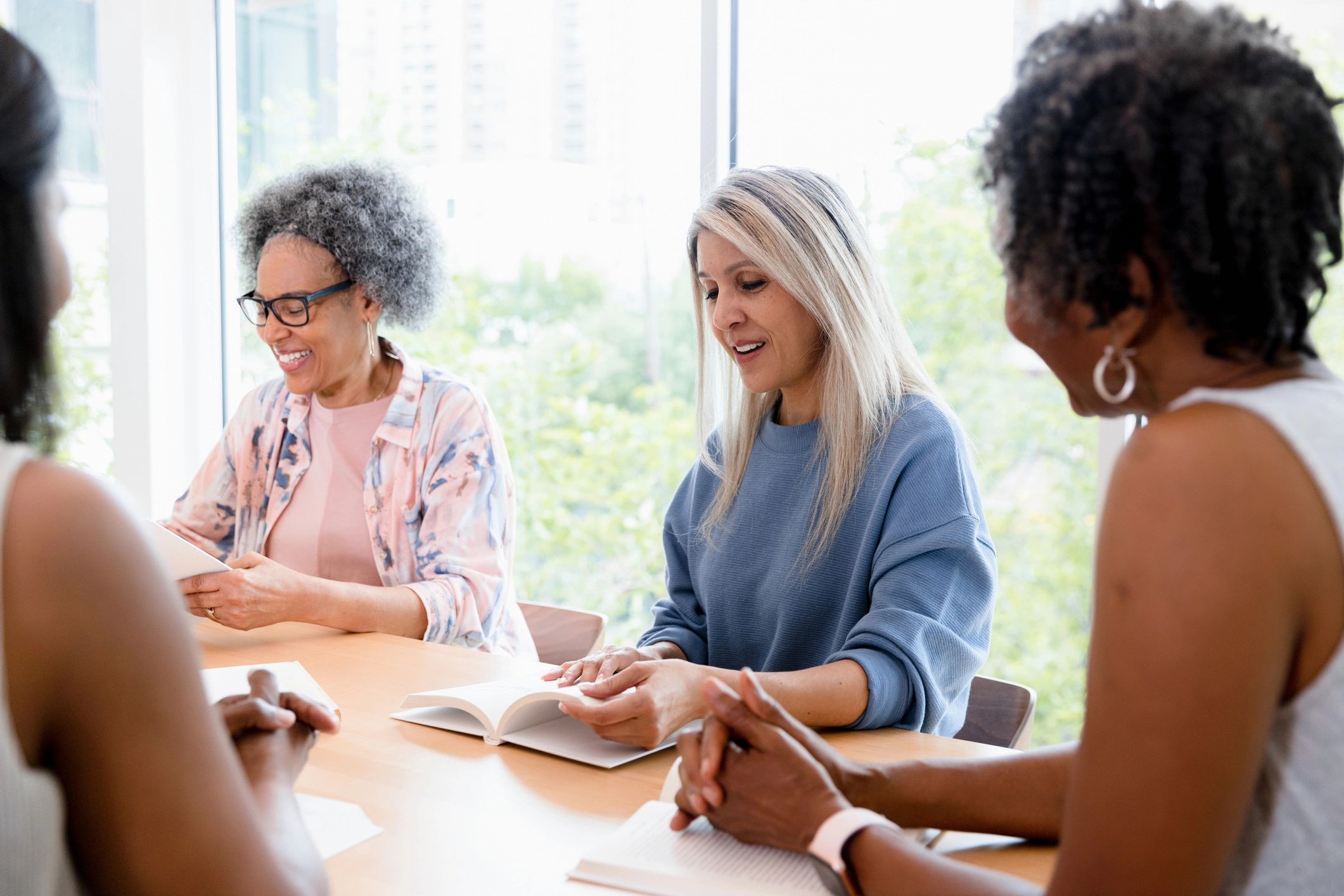 Group of women discussing a book together
