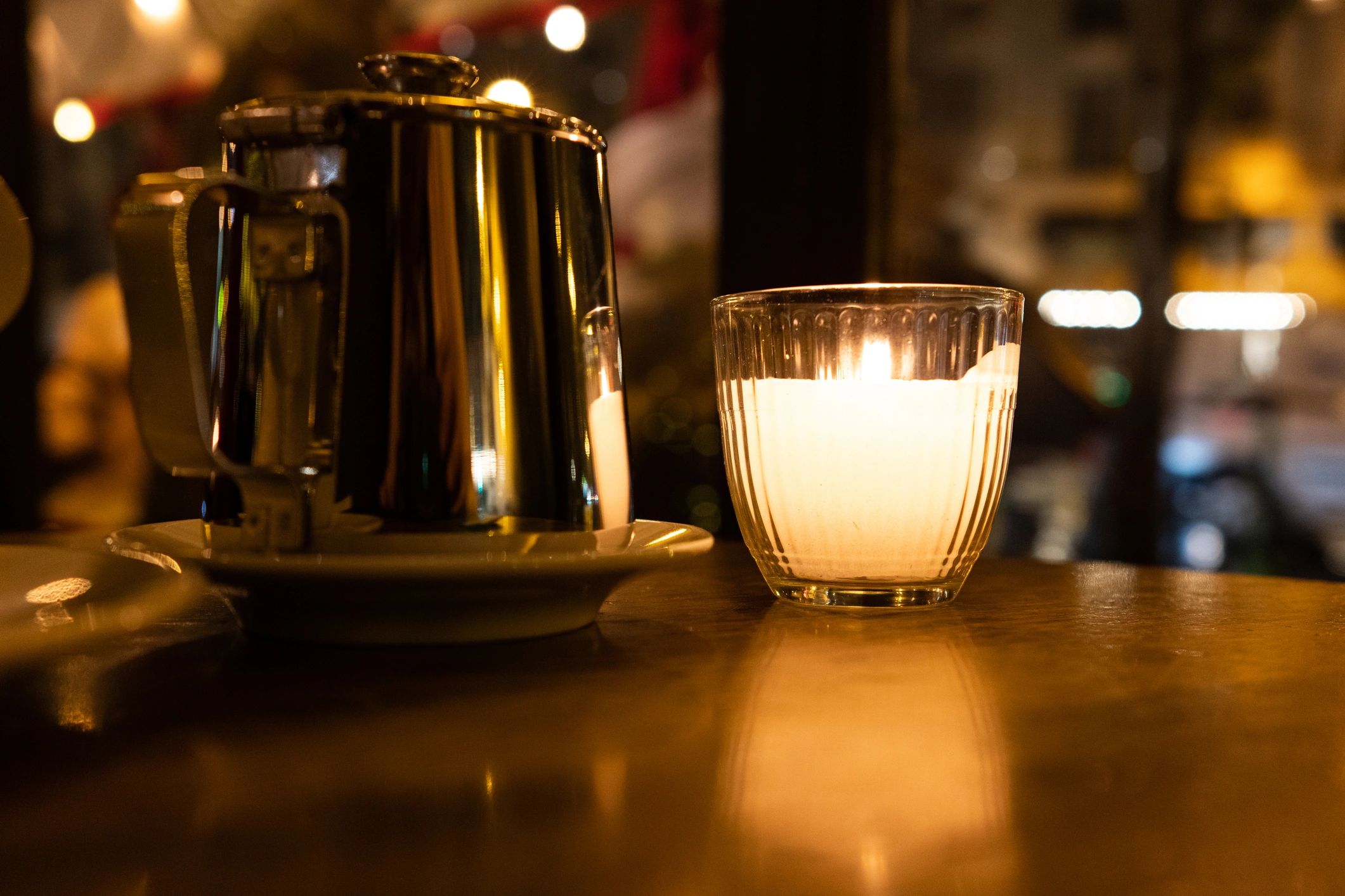 Teapot and candle on a table creating a quiet reflective writing atmosphere