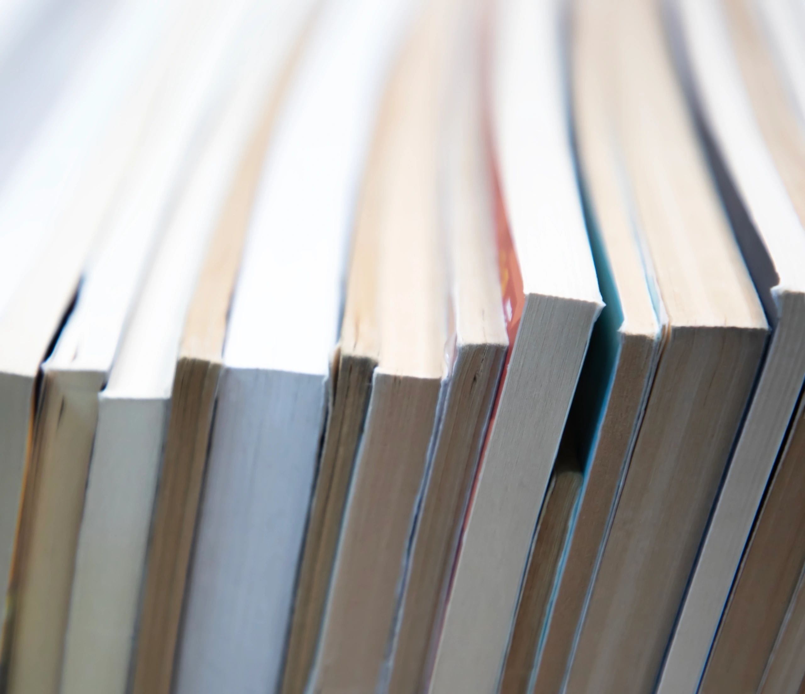 Stack of books with visible pages and warm neutral tones
