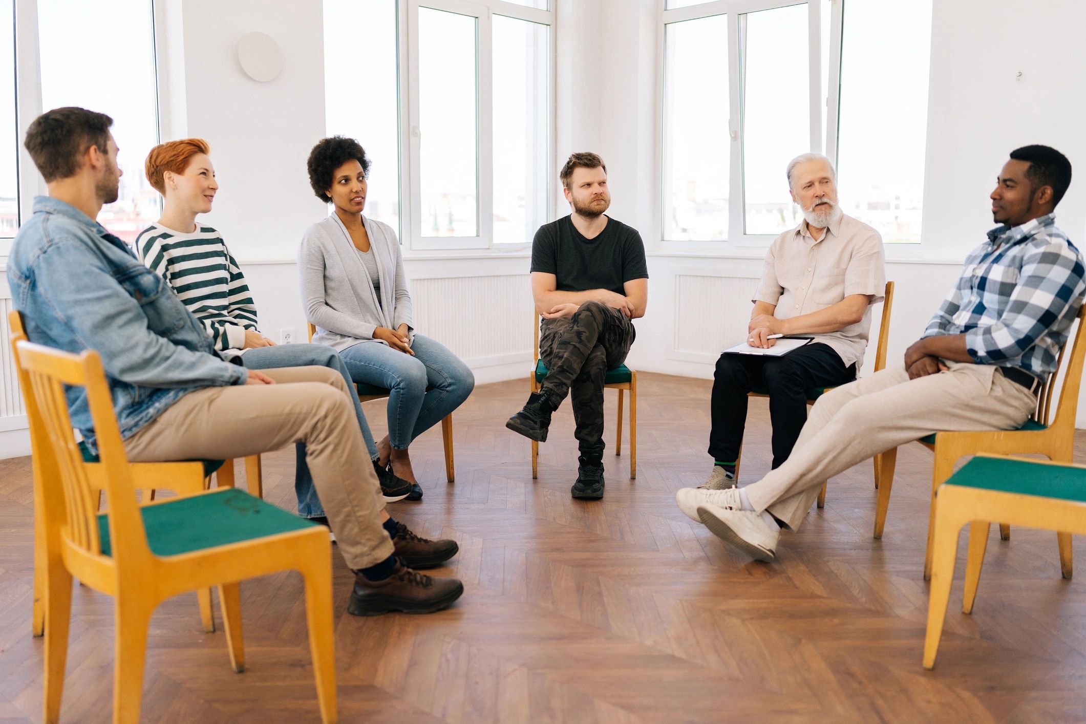Diverse group seated together in a circle