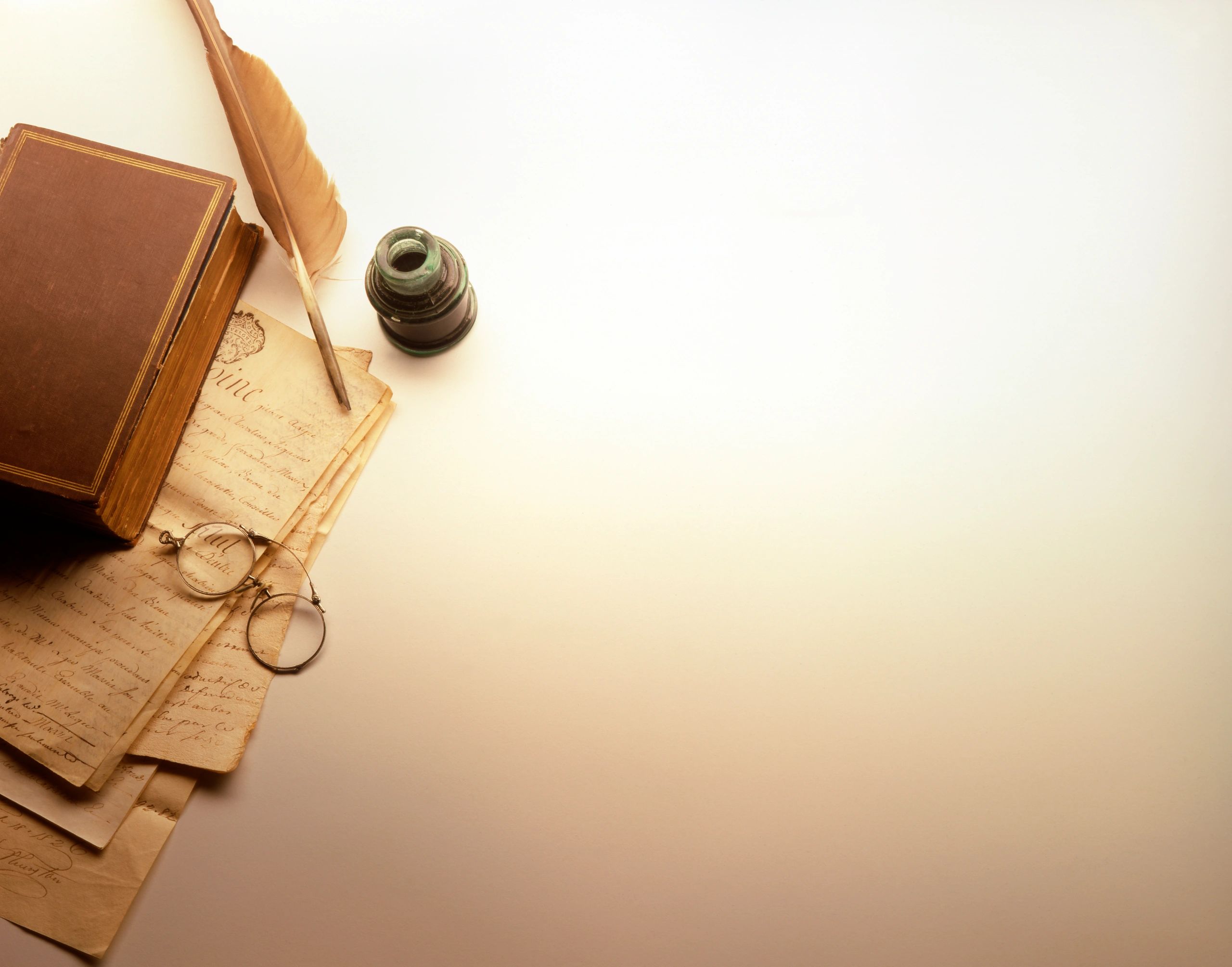 Quill and antique papers for plotting romance stories