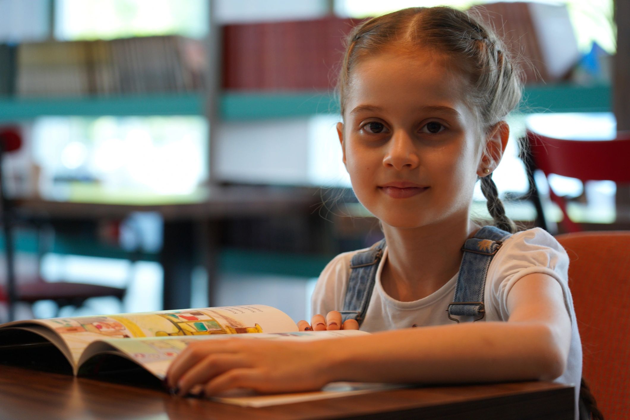 Girl reading a book in a library