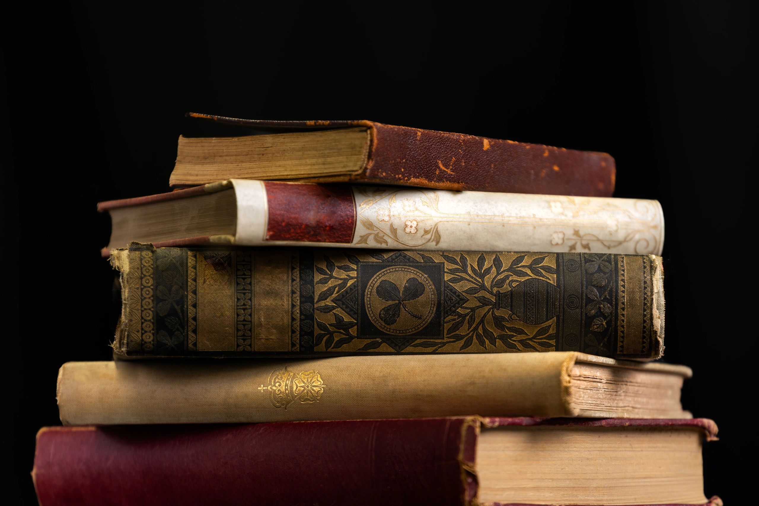 Stack of antique books with ornate covers