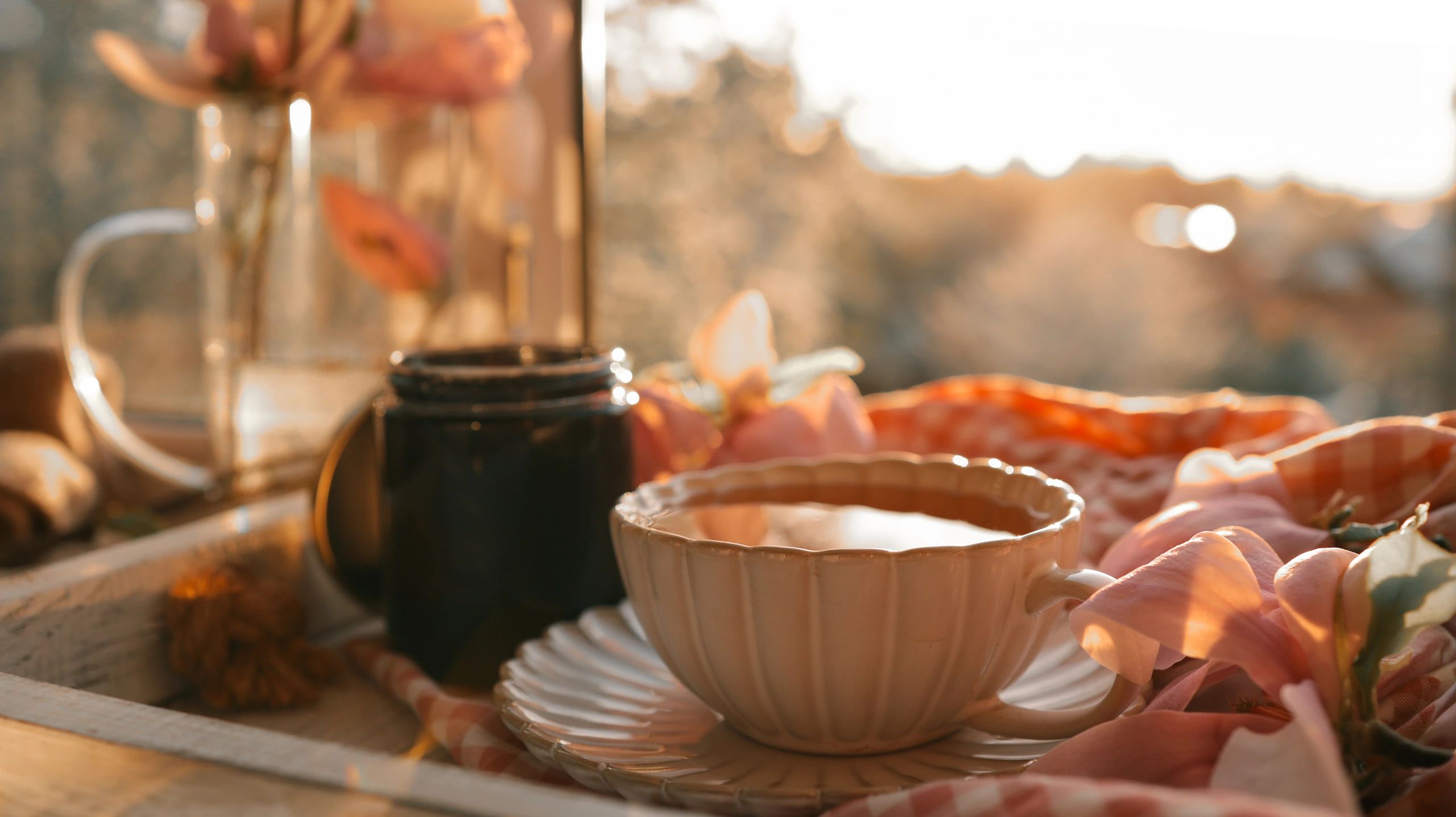 Steaming tea with flowers in warm light for gentle mystery atmosphere